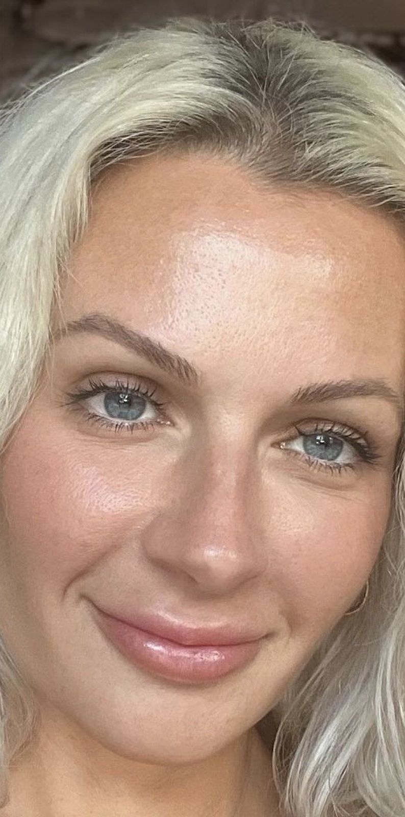 smiling woman with light blonde hair and blue eyes winchester